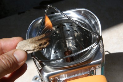 The Biolite comes with some oil soaked tinder. It smells bad but works good. Leave the fan off until your biomass is going or it will put it out. 