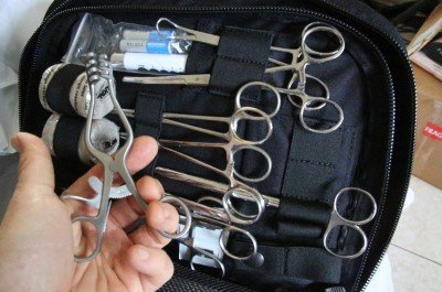 Your medical kit should have scissors, hemostats, and tweezers. You can also find disposable scalpels, and you should have at least one heavy knife. 