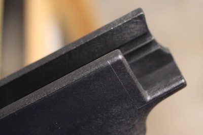 The cut on the right side allows finger access. The shelf on the left side keeps the finger in place.