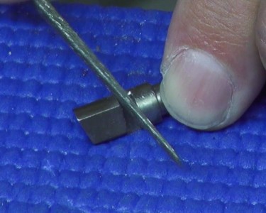 The author uses a diamond file to reshape part of the extractor.