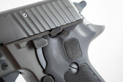 The slide stop lever and decocking lever are lower profile, smaller, and have a checkering pattern.