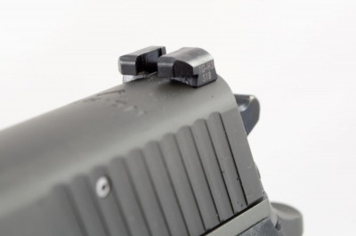 The rear sight body is shaped for one-handed slide rack operation.