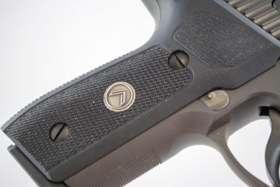 There is an aggressive checkering pattern on the front of the grip.