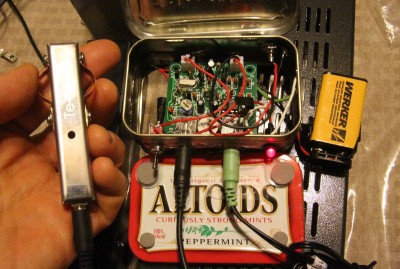 The classic QRP radio in the Ham world is built into an Altoids tin. Out of curiosity I bought this one on Ebay because it came with a mini antenna tuner, and inside I found the "other" Pixie board on Ebay, the one that doesn't have the 5.5mm jack installed in it. This guy taped together two Altoids tins so he'd have room for the battery, and for some reason put an RCA plug for the antenna. But it works! The keyer in my hand is the Te-Ne-Ke portable iambic keyer linked above. This Pixie doesn't support the stereo cord dit/dah either. 