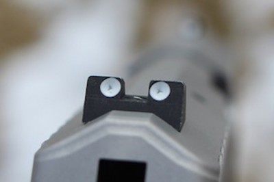 The steel rear sight is adjustable and has a locking screw.