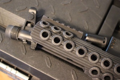 Rock the forend over the front sight. You will likely need to take off the muzzle device.