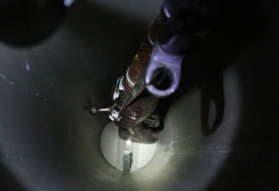 The cylinder has fins at the bottom that the butt of the rifle fits in.