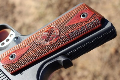 Grips are wooden, and have the SA loge and excellent texture. 