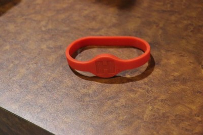 An RFID chip in the band unlocks the safe.  