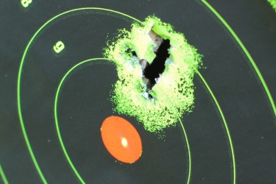 Note the red dot on the red dot. Out of the box it shoots a little high from 15 yards, but 7 rounds in one hole make up for that. 