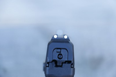 Steel sights with two dots on the rear. Notice the striker is no longer painted red.