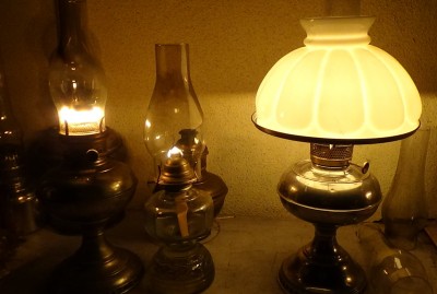 On the right is a Rayo llamp with a shade. On the left is another brand of center draft lamp that takes the same wick and works essentially the same as a Rayo. In the center is a single flat wick lamp, for comparison.  See below for pics with a book to read by your lamp. 