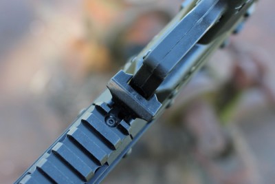 The stock lever, in front of the trigger guard. 