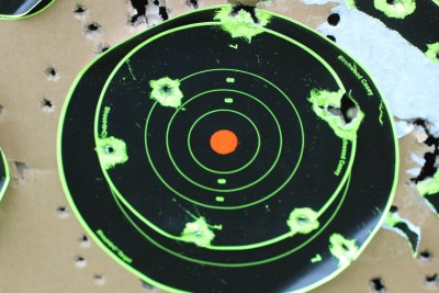 We shot standing at 100 yards with the irons. The results aren't MOA, but this is standing with a very heavy gun shouldered.