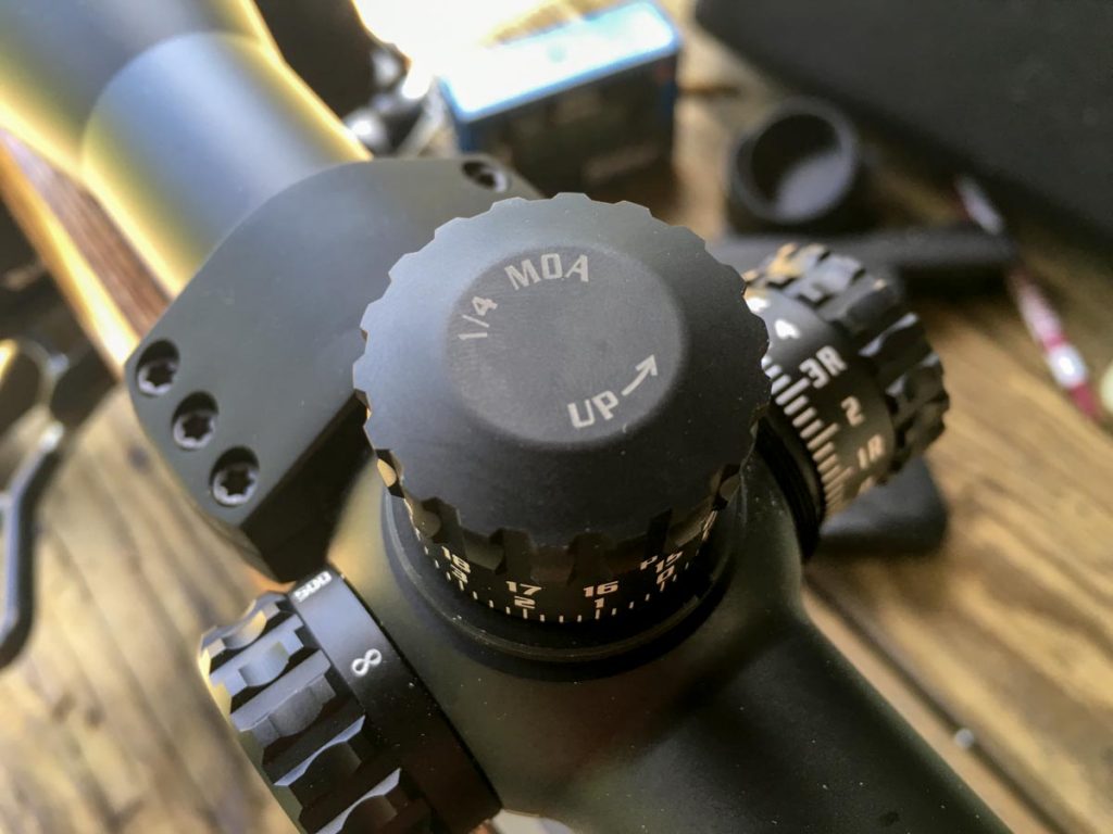 Most scope dials will indicate the amount of adjustment per click. This Burris Veracity adjusts 1/4-inch at 100 yards per click.