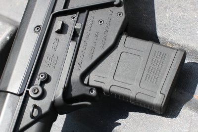 The mag release is a piece of spring steel that wraps around the mag. 