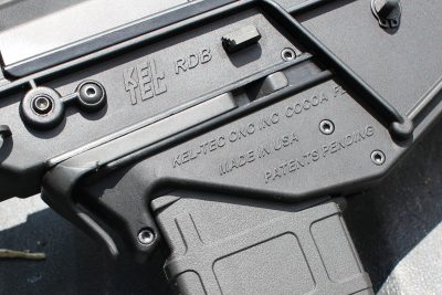 The mag release paddle is central on the frame, while the bolt release (the small trapazoidal lever) is on both sides. 