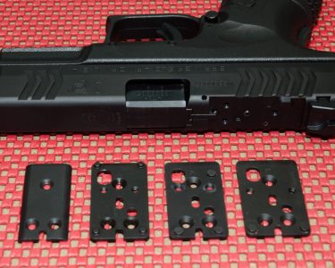 The XDM OSP uses three adapter plates to accommodate a number of popular reflex sights. The Melonite cover is used when no optic is mounted.