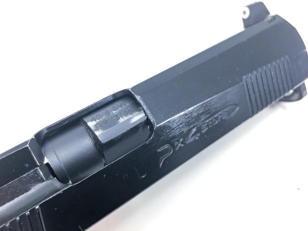 You can see where the barrel locks to the front right edge of the ejection port. There's a second locking point on an internal ledge in the slide. 