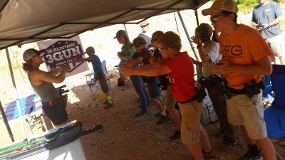 Lena Miculek, instructing juniors on the finer points of how to properly grip a pistol. 