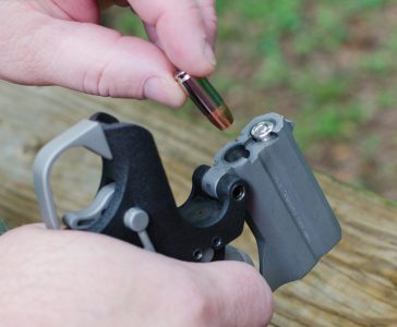 21st Century Derringer! Bond Arms Back Up .45 ACP & 9mm Defender—Full Review The Backup employs a top-hinging barrel system and dual barrels. The author is shown here loading it with 9mm.