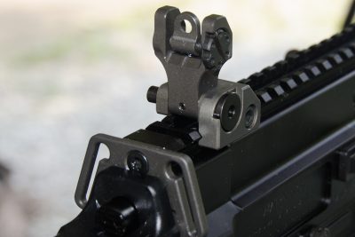 The folding rear sight unit features dual apertures and locks solidly into place. 