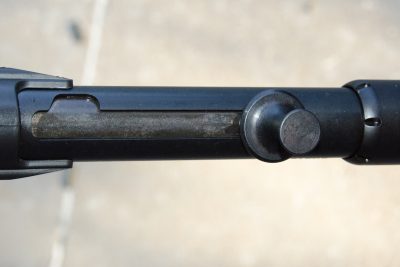 The cocking handle runs in a channel with a notch that allows the action to be locked open.