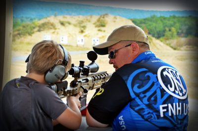 FN USA's Tabor Bright, working with a junior shooter at a side match event. Side matches are events incorporated into competitions, designed to both showcase guns and introduce new shooters in a friendly, one-on-one environment. 