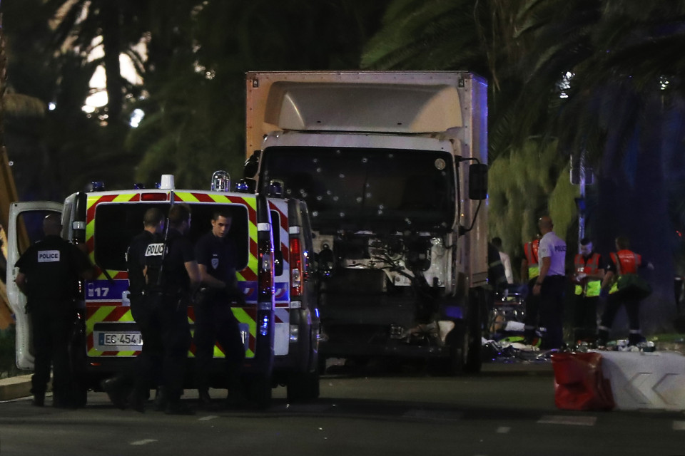 Police officers and rescued workers stand near a van that ploughed into a crowd leaving a fireworks display in the French Riviera town of Nice on July 14, 2016. The mayor of the French city of Nice said dozens of people were likely killed after a van rammed into a crowd marking Bastille Day in the French Riviera resort today and urged residents to stay indoors. / AFP PHOTO / VALERY HACHEVALERY HACHE/AFP/Getty Images