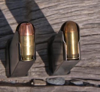 The .50 GI (left) and the standard .45 ACP (right) versions of the pistol both use proprietary magazines. Note the rebated rim of the .50 cartridge.