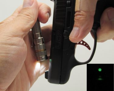 The photoluminescent front sight must be “charged” before use. A small LED pocket light is the perfect tool for this task. The inset photo shows how bright the insert glows after charging.