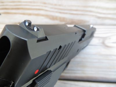 A set of steel, white dot iron sights sit atop the sturdy and somewhat blocky slide of the pistol.