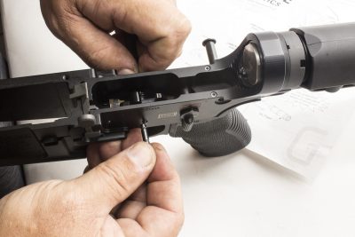 STEP 4: Install trigger into rifle. Align trigger pin bore with receiver pin holes. Insert trigger pin into receiver, through trigger disconnector, and into receiver on opposite side. Do not force the pin. The pin is a slide fit into the receiver, trigger and disconnector. If the various components are not aligned, manually align them when looking through the opposite side of the pin hole.