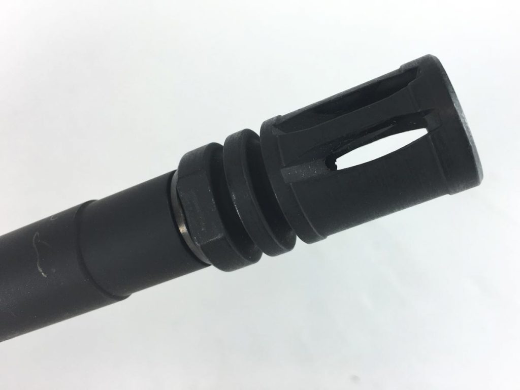 The rifles comes with a standard birdcage flash hider timed with a compression washer. If you want to change muzzle devices, the thread pattern is standard 1/2x28.