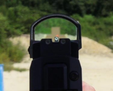 The ROMEO1 co-witnessed nicely with the tall iron sights for the author.