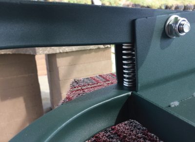 When you turn the knob counterclockwise, the spring pushes the arm back down. 