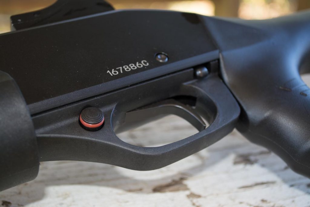 The crossbolt safety is just forward of the trigger while the slide release catch is behind on the left side. 