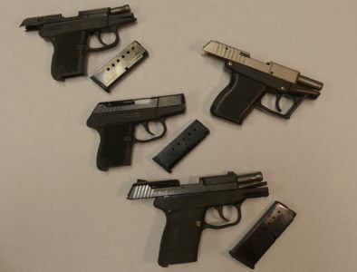 Pocket pistols with magazines laid beside them