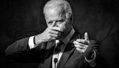 Biden pretending to hold a gun.