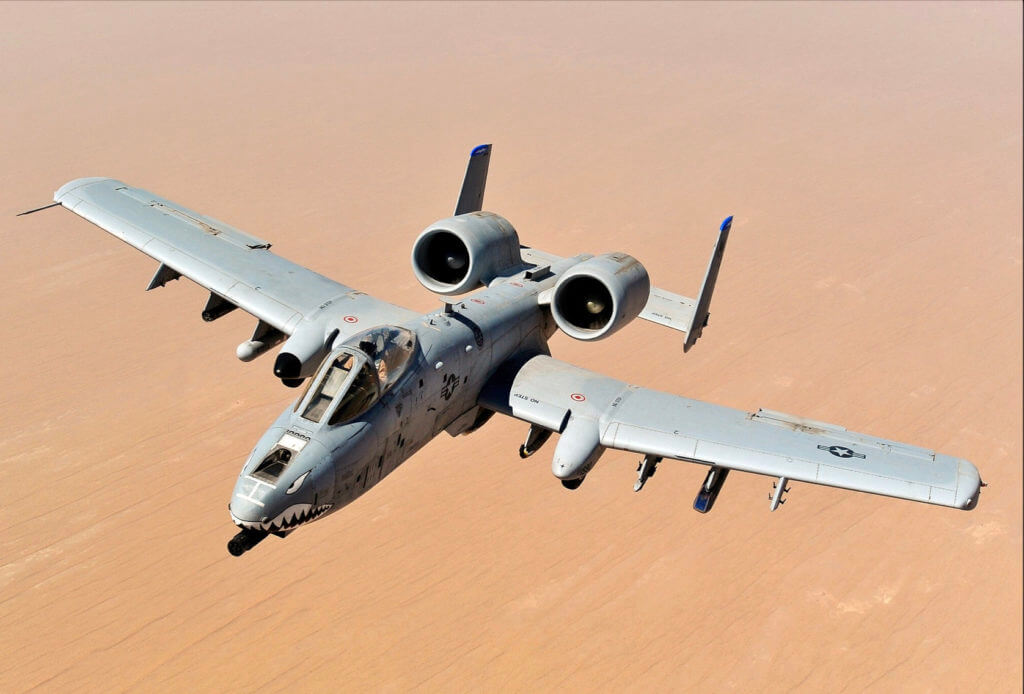 A-10 airplane soaring over desert landscape