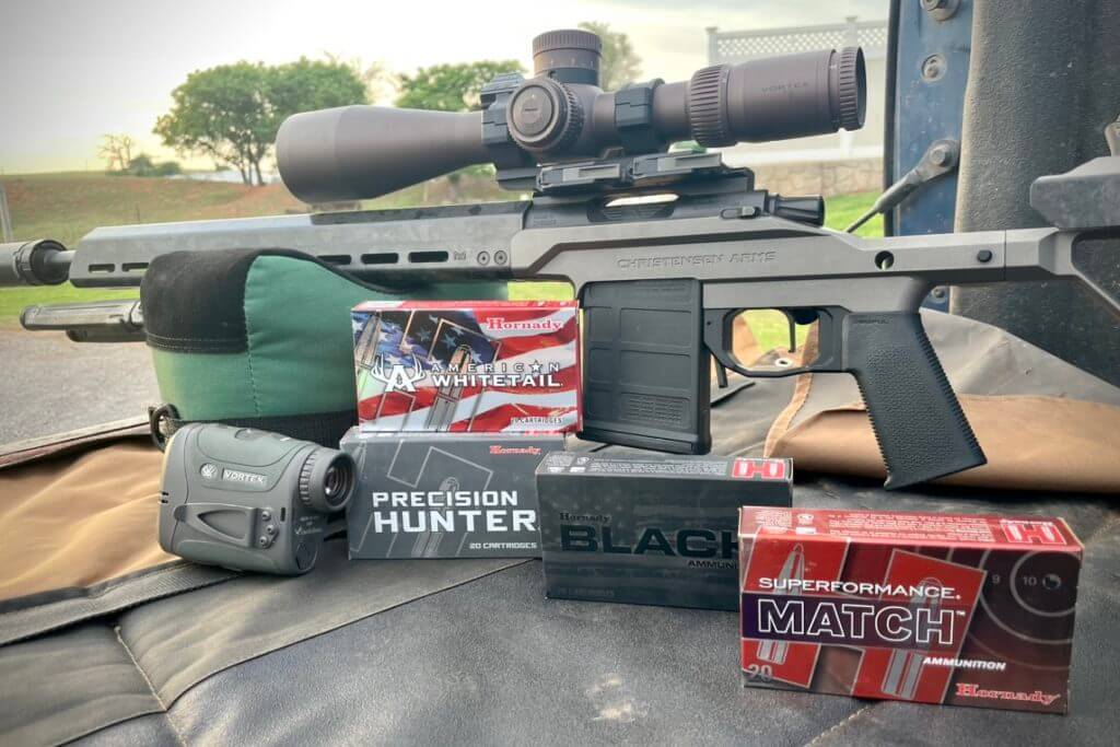 2 - Review: Christensen Arms MPR Put to the Test Hornady ammunition stacked up for accuracy testing next to the MPR and the Vortex Razor HD 4000 GB Ballistics rangefinder