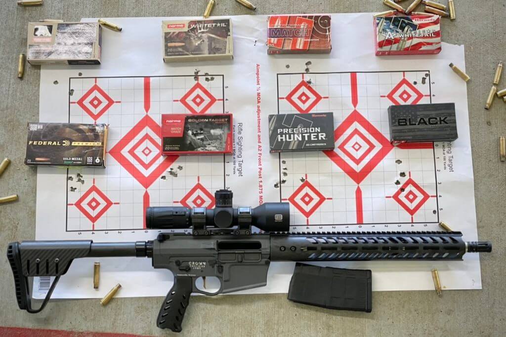Meet the Ultralight Crown Precision Elite AR10 Testing the precision of the Crown Precision Elite. Boxes of ammunition are placed next to their respective groups.
