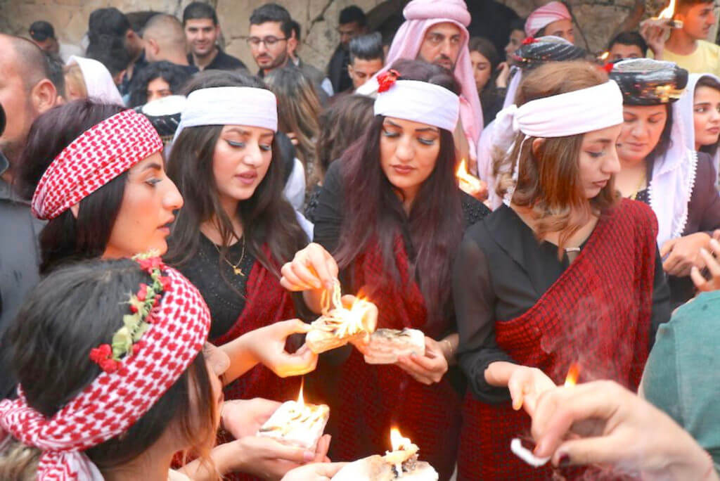 middle eastern women standing around with candles
