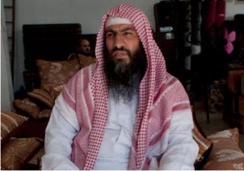 abu sayyaf sitting in a room