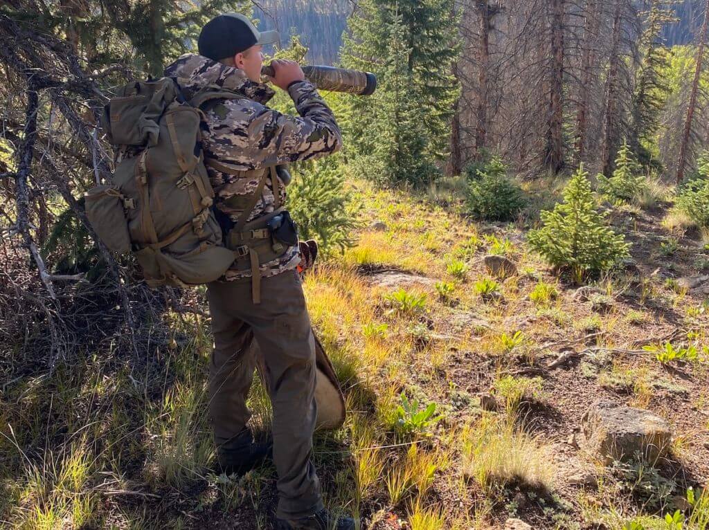 Hunter in the backcountry blowing through his elk bugle