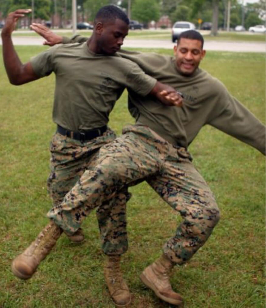 two soldiers practicing martial arts on a grass
