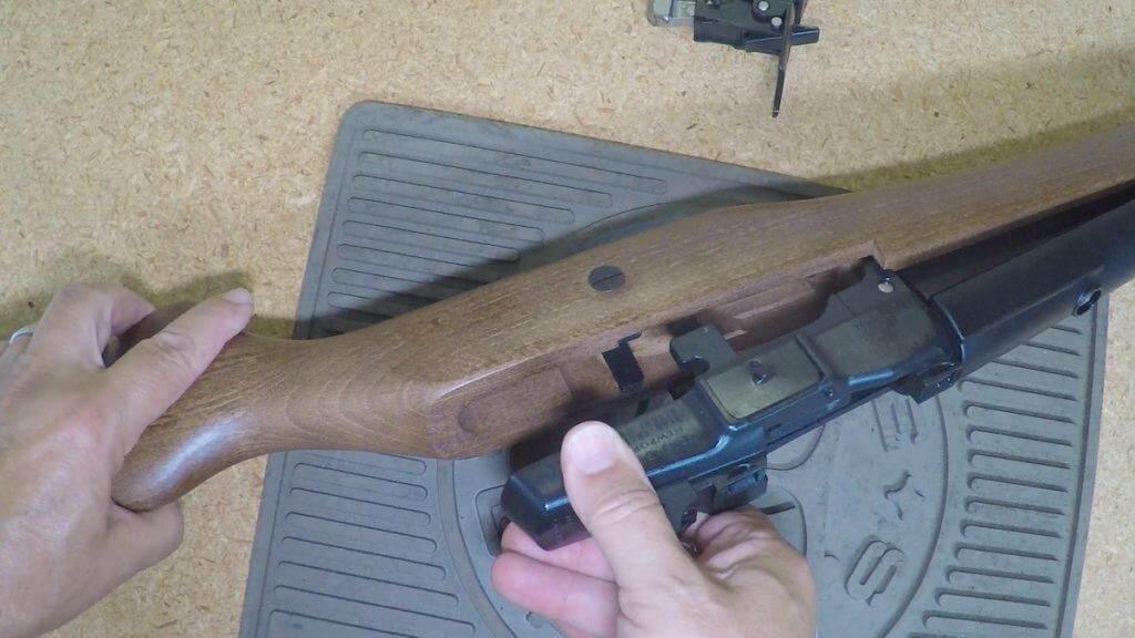 Pulling the barreled action from the stock on a Ruger Mini-14 Ranch Rifle.