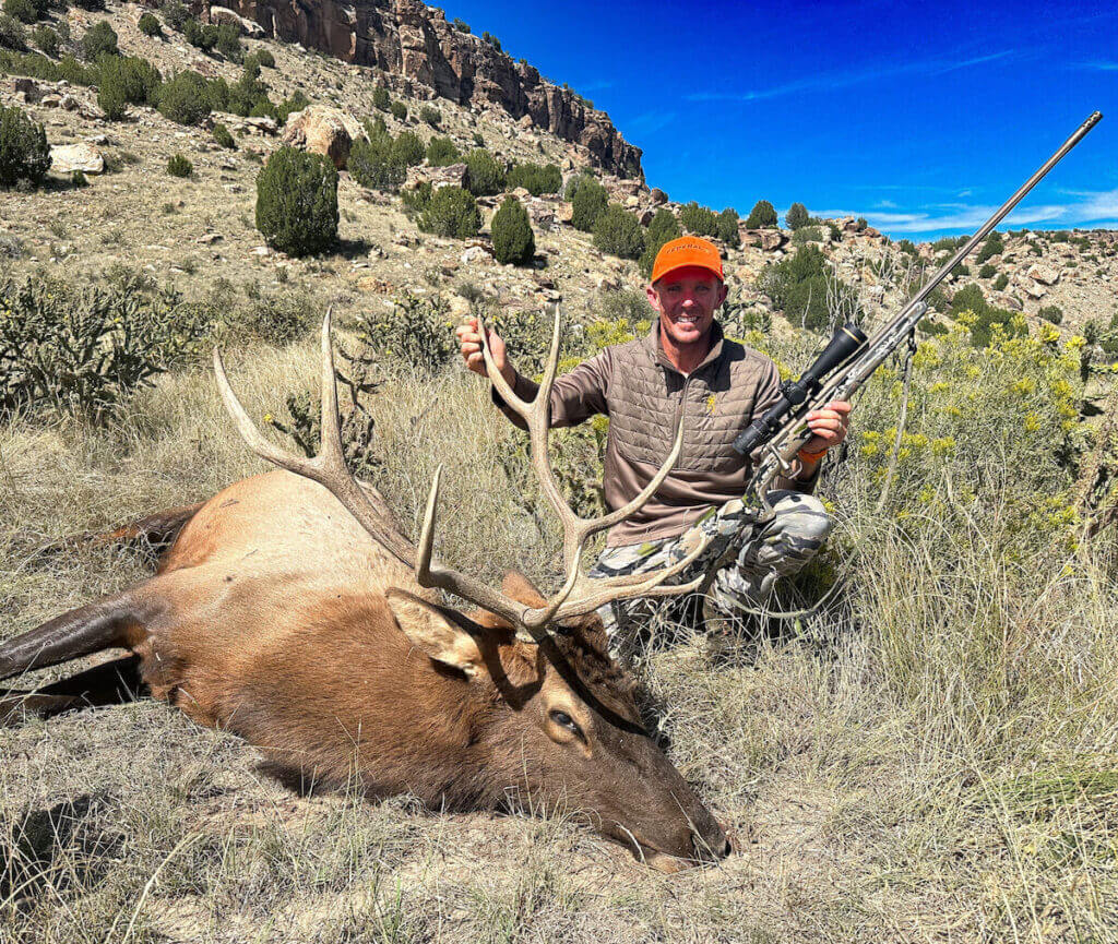 Hunter with Browning Speed LR and a huge elk out in the mountains