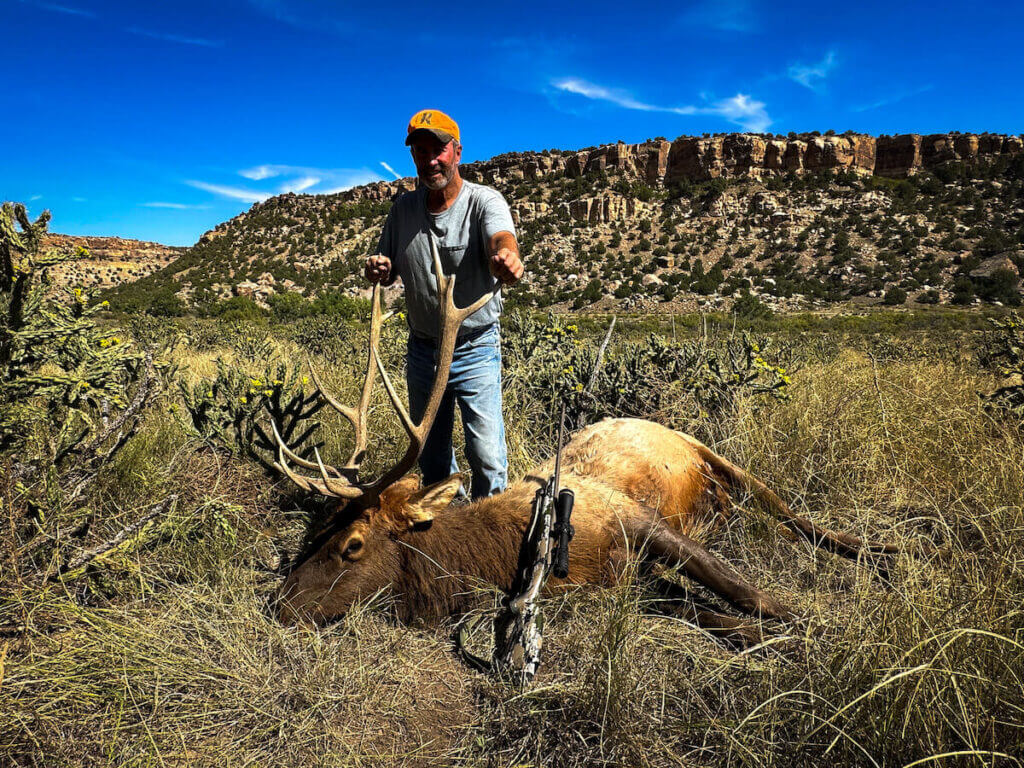 Browning Speed LR 7MM PRC Wins in the Field Hunter with elk and rifle in tall grass