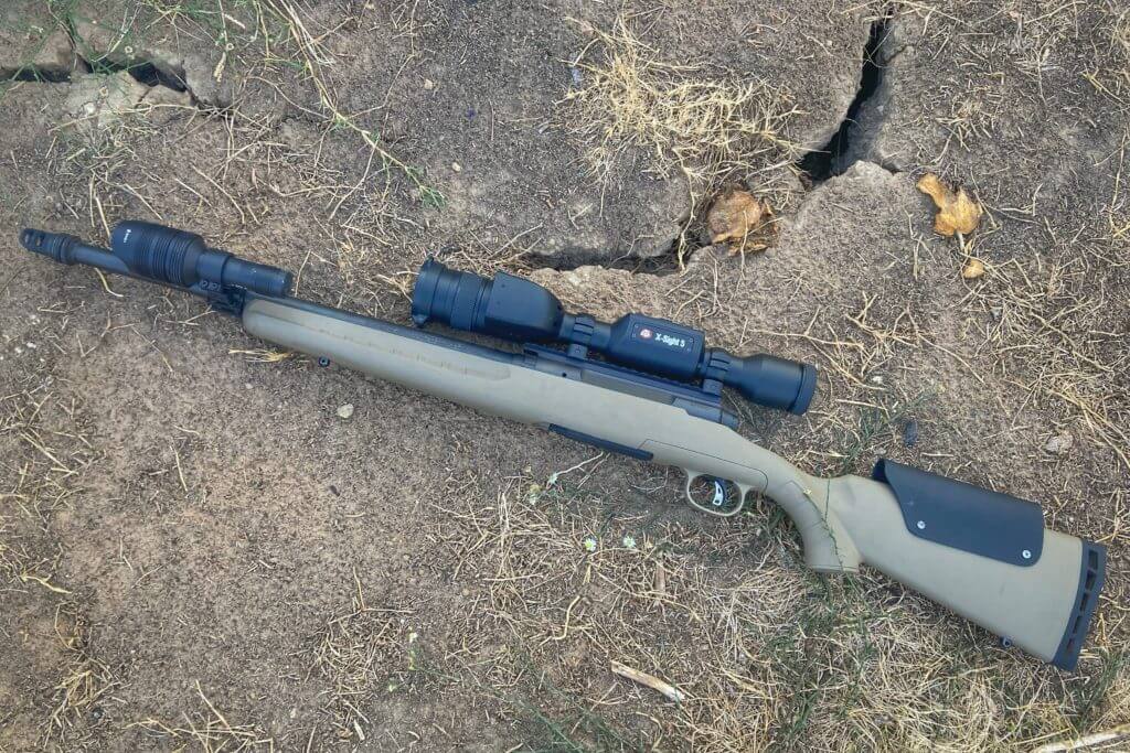 ATN X-Sight 5 LRF mounted on rifle with modifications on cracked ground